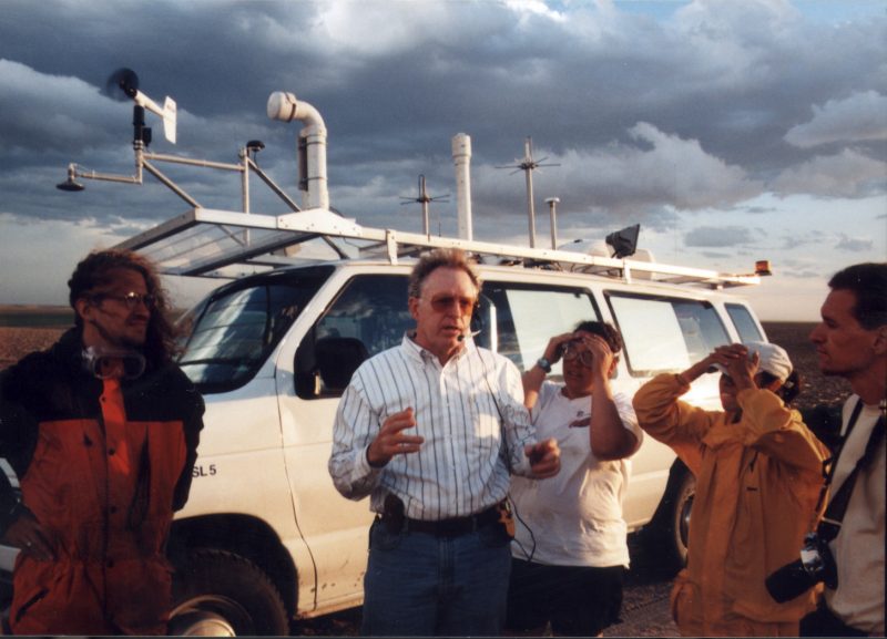 Dave Rust briefs his crew in front of a mobile lab.