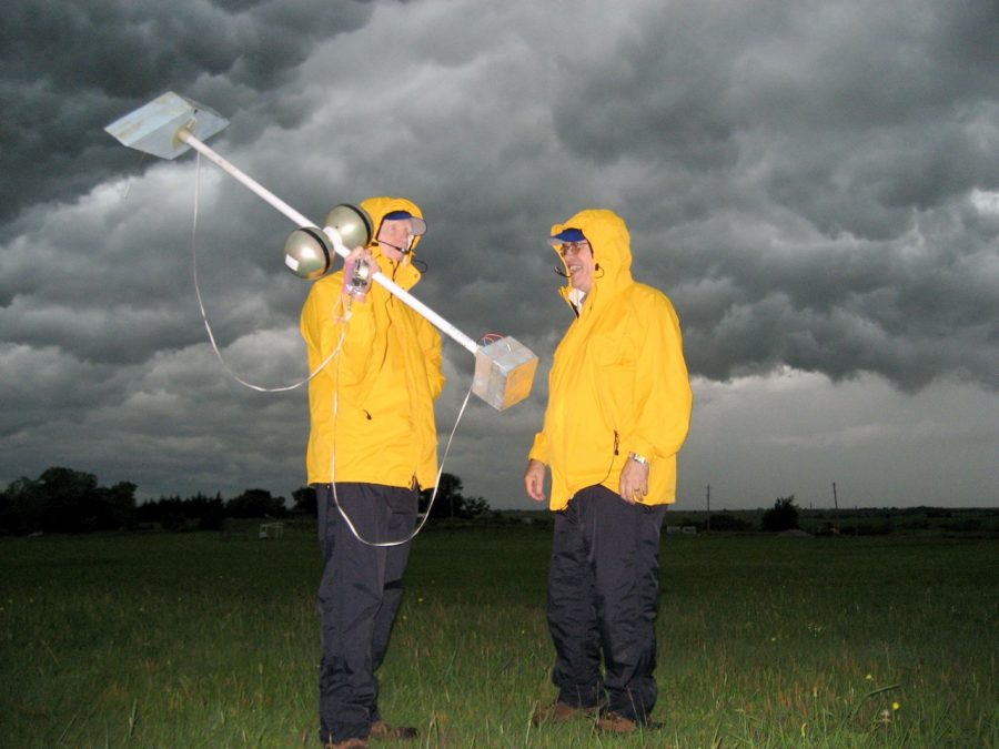 Dave Rust and Don MacGorman in a thunderstorm with weather tools.