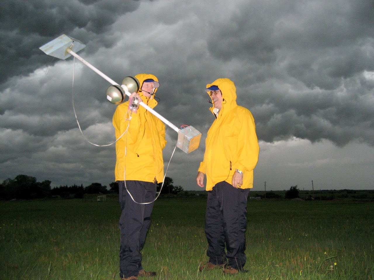 Dave Rust and Don MacGorman in a thunderstorm with weather tools.