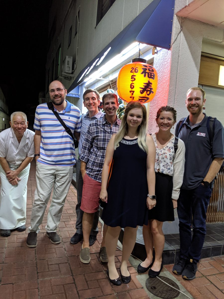 Sandmael with a group outside a restaurant.