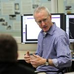 Jack Kain speaking to someone in the NOAA Hazardous Weather Testbed room