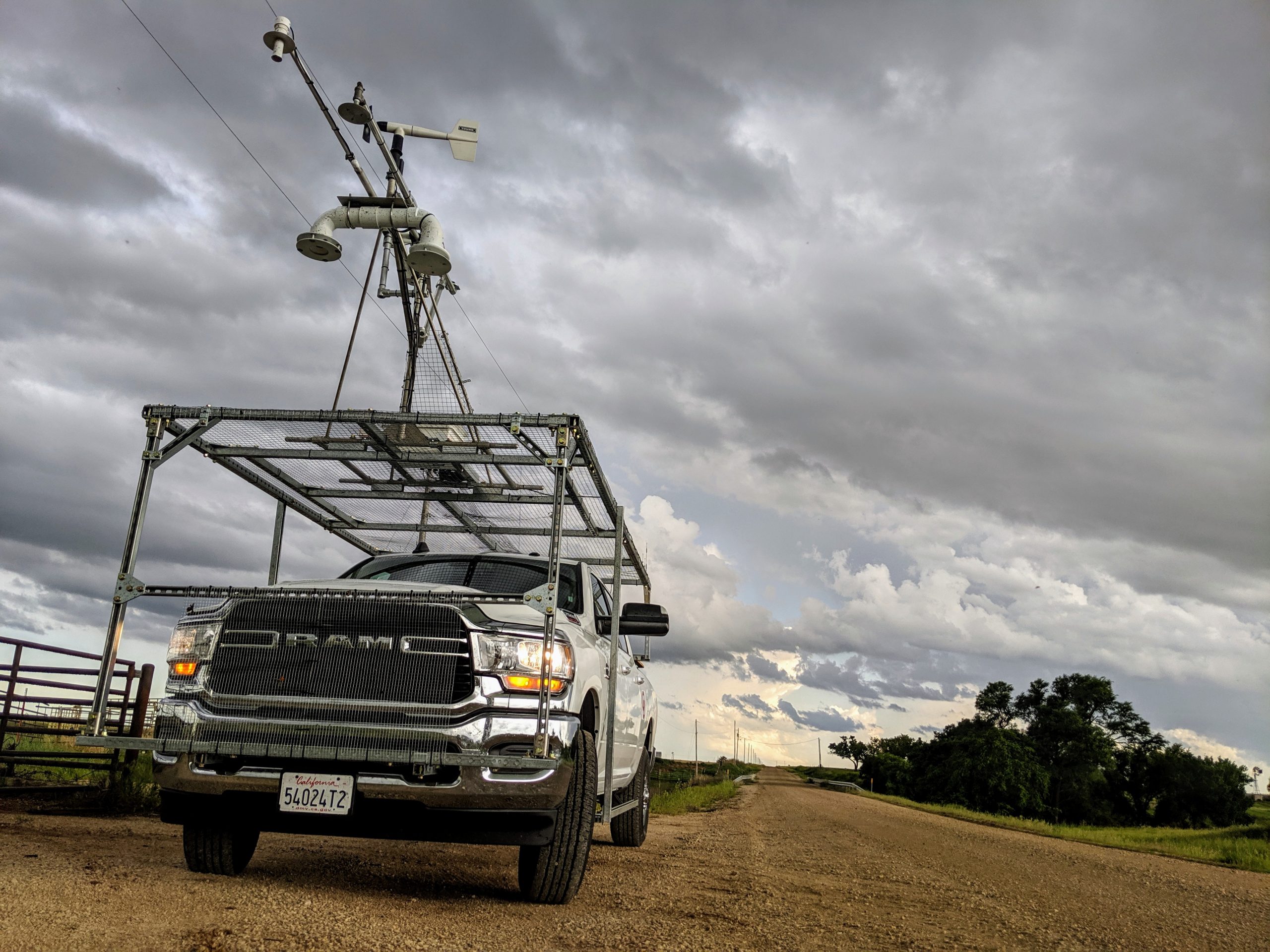 A truck with weather instruments attached on the top.