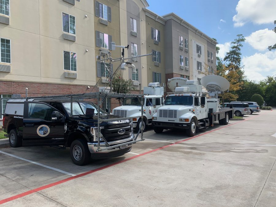 Research vehicles parked in front of a hotel.