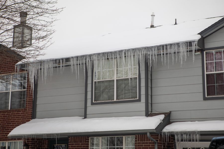 Icicles hanging from the edge of a home roof.